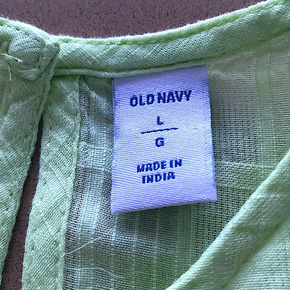 Sleeveless pastel green blouse with frills and a button detail at the back. - Picture 3 of 3